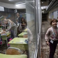 children learning in an underground bunker
