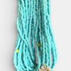 Turquoise beaded multi-strand necklace with a gold sunflower pendant