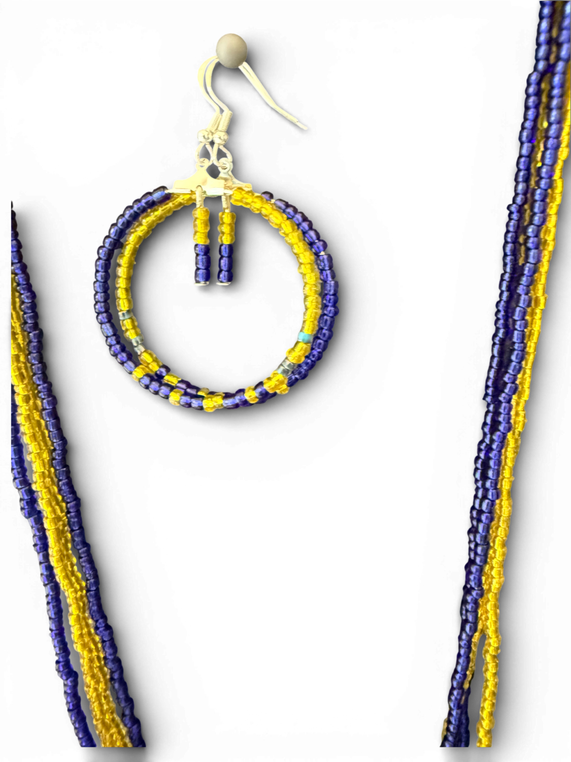 Beaded circular hoop in yellow and blue with a hanging skeletal charm, set against a black background.