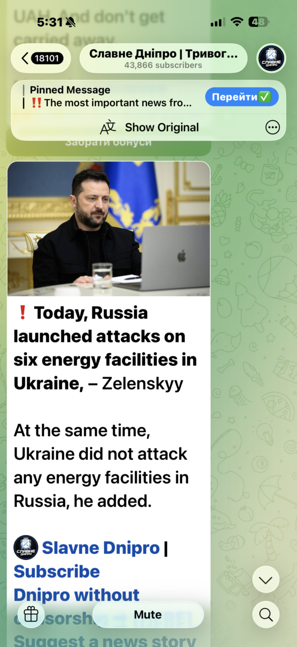 IMG_8400 News app screenshot: man seated at a desk with a laptop, bold headline about Russia attacking energy facilities in Ukraine.