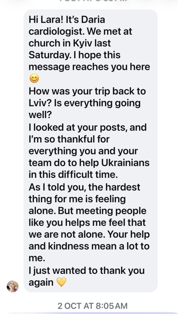 Screenshot of a long text message: greeting to Lara from Daria the cardiologist, asking about a trip back to Lviv, expressing gratitude for helping Ukrainians, and mentioning feeling lonely, ending with a yellow heart emoji.